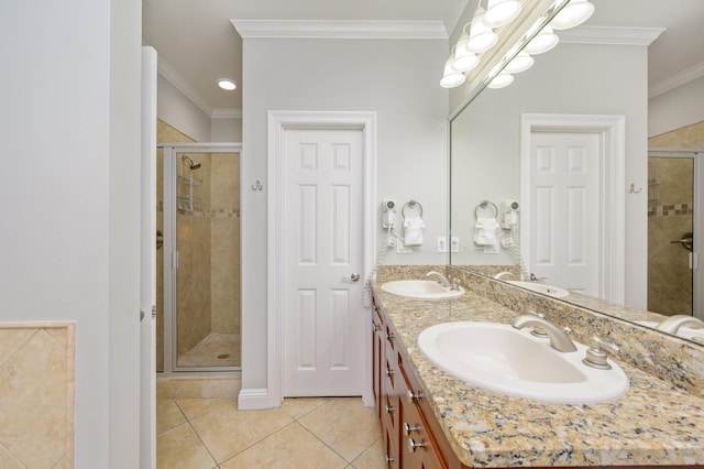 bathroom featuring tile flooring, large vanity, double sink, crown molding, and an enclosed shower