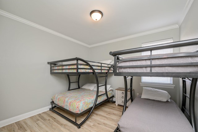 bedroom with light hardwood / wood-style floors and crown molding