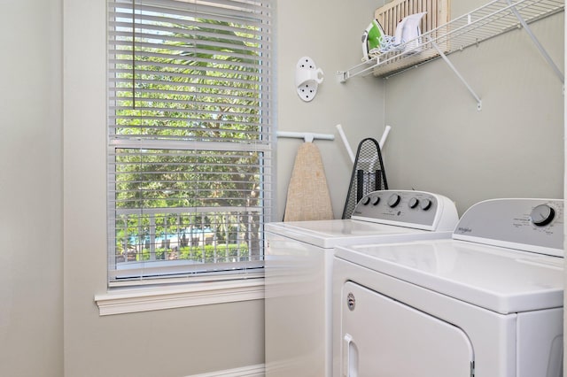 laundry area featuring a healthy amount of sunlight and separate washer and dryer