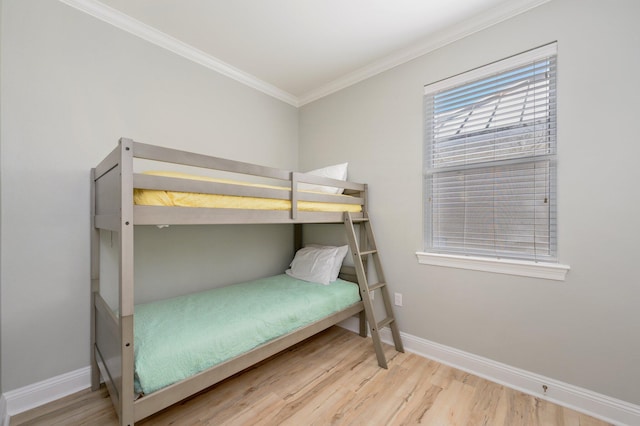 bedroom with crown molding and light wood-type flooring