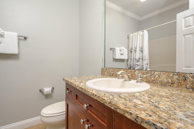 bathroom featuring toilet, vanity with extensive cabinet space, and ornamental molding