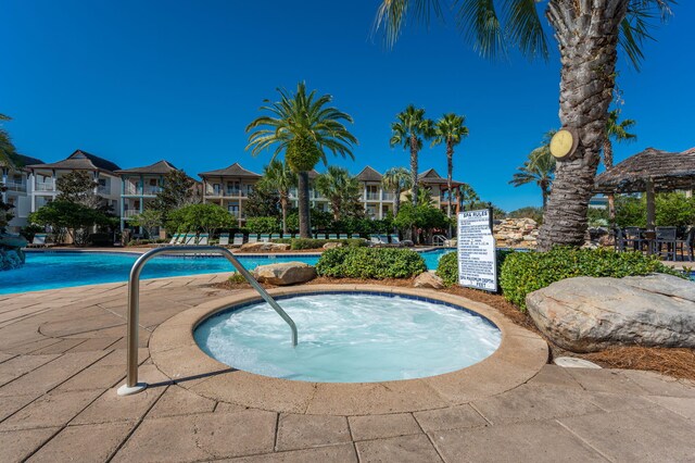 view of swimming pool featuring a community hot tub