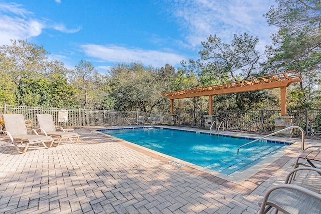 view of swimming pool with a patio area and a pergola