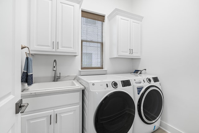 clothes washing area with cabinets, washer hookup, separate washer and dryer, and sink