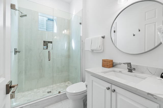 bathroom featuring vanity with extensive cabinet space, an enclosed shower, toilet, and tile floors