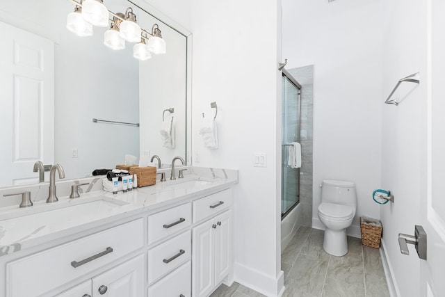 full bathroom with shower / bath combination with glass door, toilet, tile floors, and double vanity