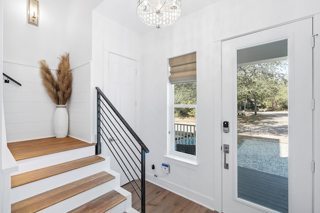 foyer featuring a chandelier and wood-type flooring