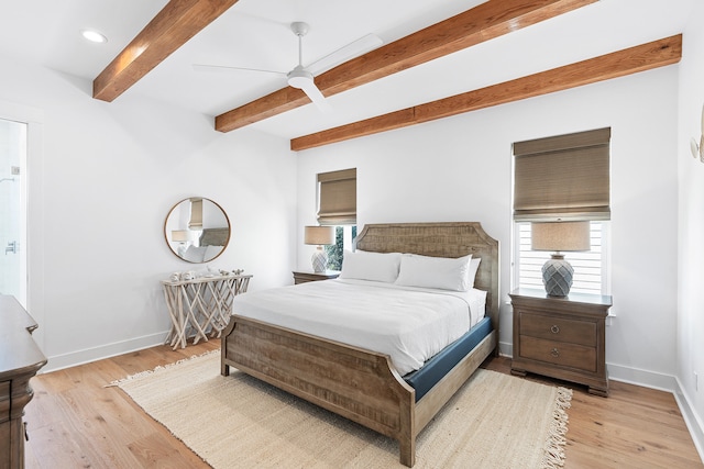 bedroom with beam ceiling, ceiling fan, and light hardwood / wood-style floors