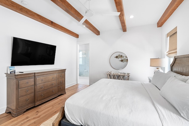 bedroom featuring beamed ceiling, ceiling fan, light hardwood / wood-style floors, and connected bathroom