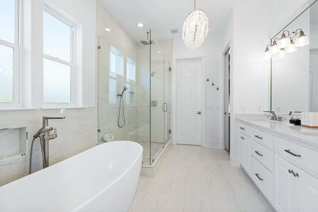 bathroom with tile flooring, vanity, shower with separate bathtub, and a wealth of natural light