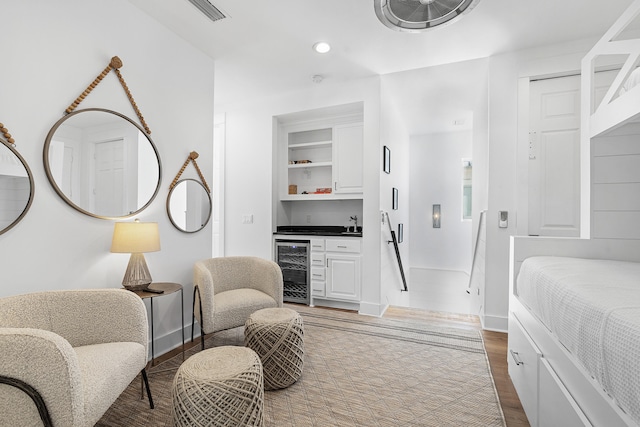 bedroom featuring hardwood / wood-style flooring and beverage cooler