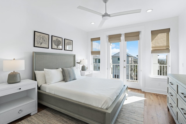 bedroom featuring hardwood / wood-style floors, ceiling fan, access to outside, and multiple windows