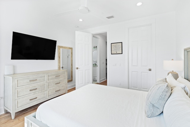 bedroom with ceiling fan and light wood-type flooring