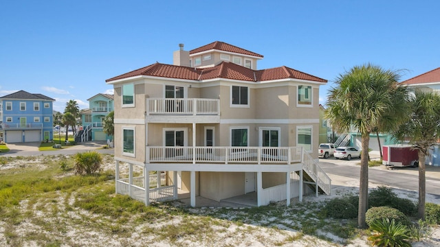 back of property featuring a garage and a balcony