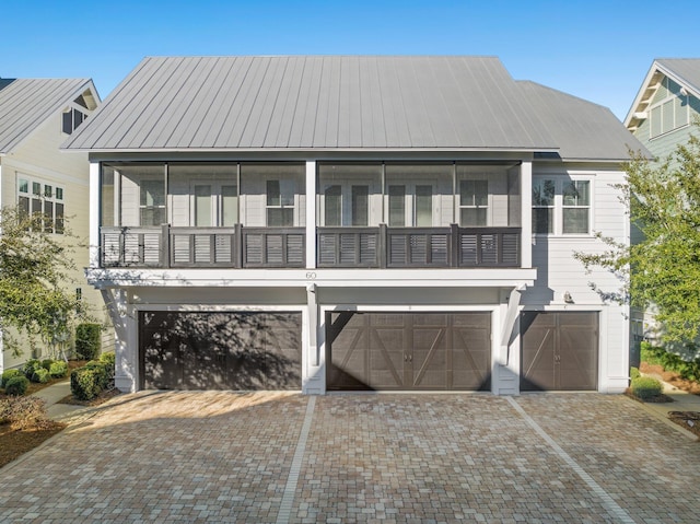 view of front of property featuring a balcony and a garage