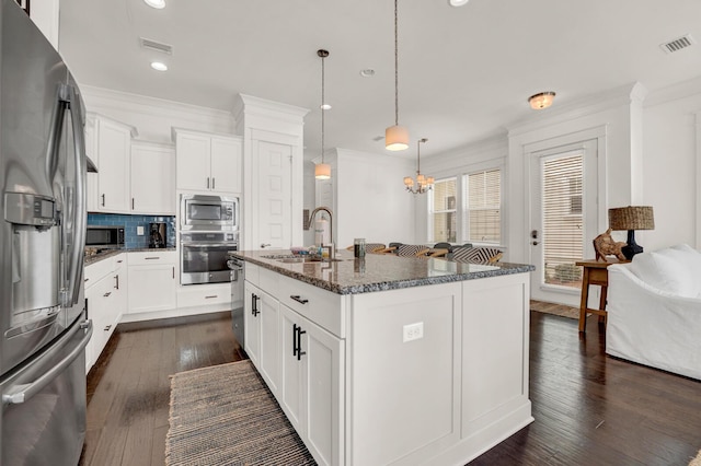 kitchen featuring white cabinetry, appliances with stainless steel finishes, sink, and a kitchen island with sink