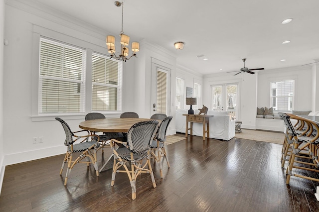 dining room featuring crown molding, ceiling fan with notable chandelier, and dark hardwood / wood-style flooring