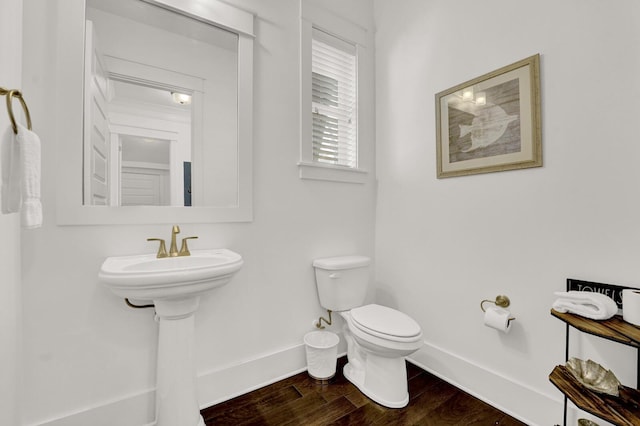 bathroom featuring wood-type flooring and toilet