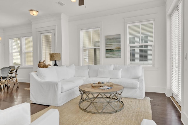 living room featuring crown molding, dark hardwood / wood-style flooring, and ceiling fan with notable chandelier