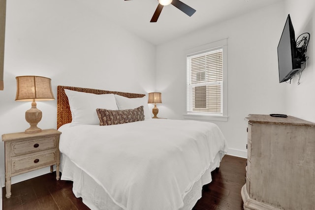 bedroom with dark hardwood / wood-style floors and ceiling fan