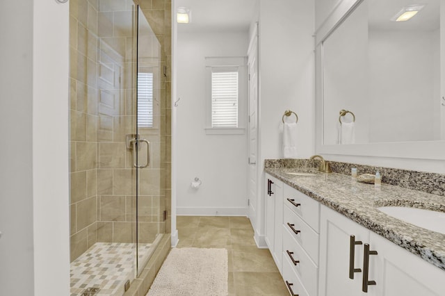 bathroom featuring an enclosed shower, vanity, and tile patterned flooring