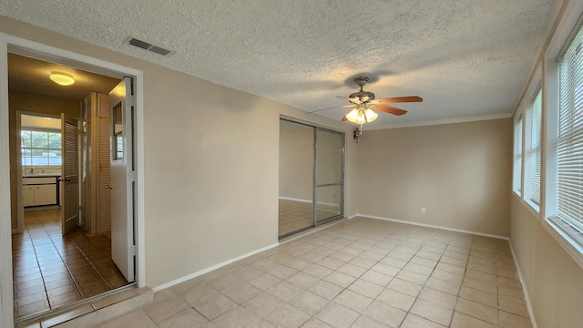 unfurnished bedroom with light tile patterned floors, a closet, ceiling fan, and sink