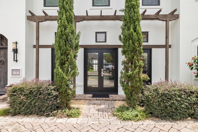 property entrance featuring french doors and a pergola