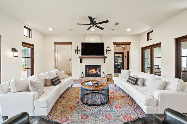 living room with ceiling fan and hardwood / wood-style flooring