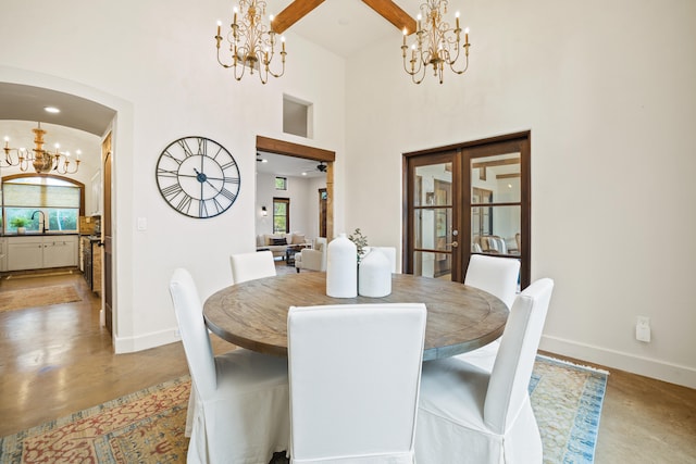 dining room featuring ceiling fan with notable chandelier and sink