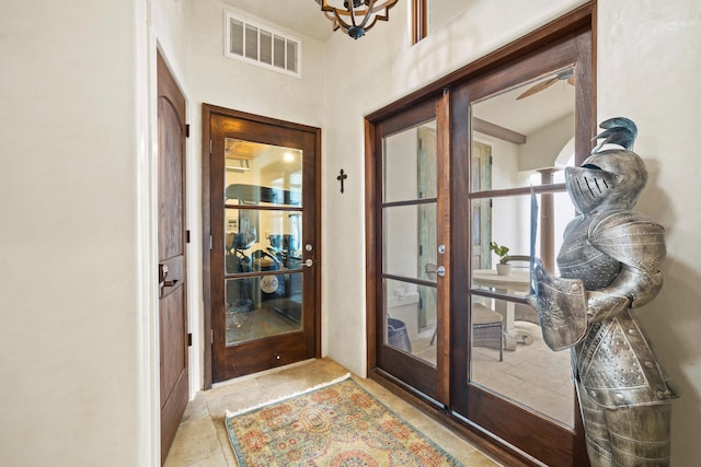 doorway to outside featuring french doors, ceiling fan, and light tile floors