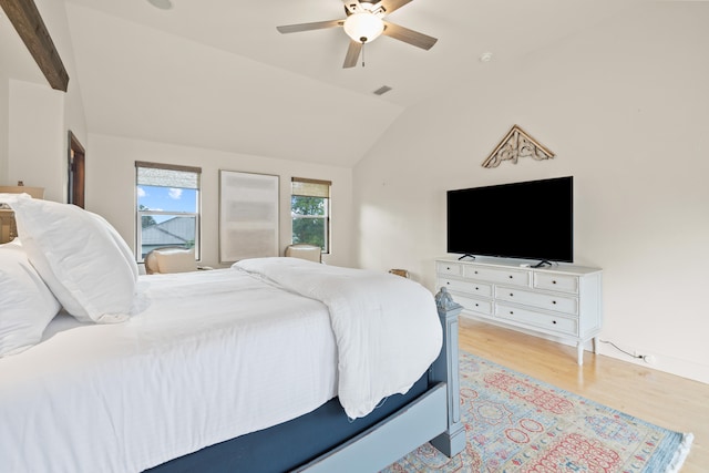 bedroom with ceiling fan, vaulted ceiling, and light wood-type flooring