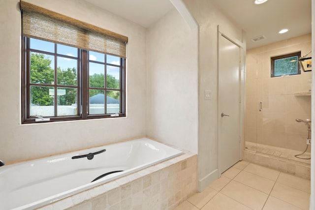 bathroom featuring tile flooring and shower with separate bathtub