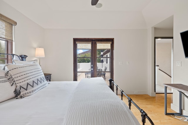 bedroom featuring french doors, ceiling fan, light wood-type flooring, and access to outside