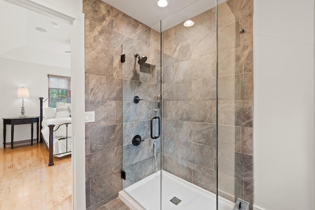 bathroom with walk in shower and hardwood / wood-style flooring