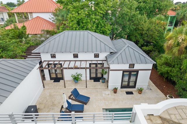 back of property with a patio area and french doors