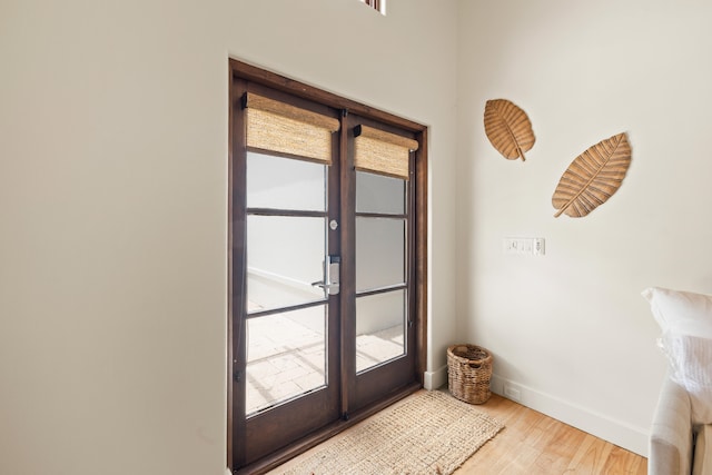 entryway with light hardwood / wood-style flooring and french doors