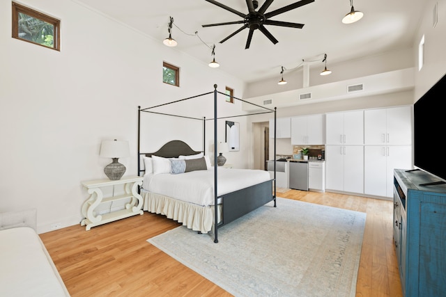 bedroom with ceiling fan and light wood-type flooring