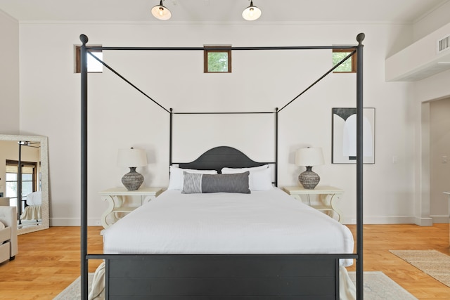 bedroom featuring multiple windows and light wood-type flooring