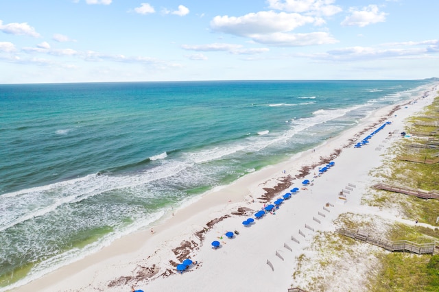 drone / aerial view with a water view and a beach view