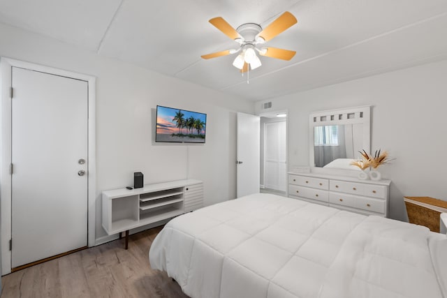 bedroom with ceiling fan and light wood-type flooring