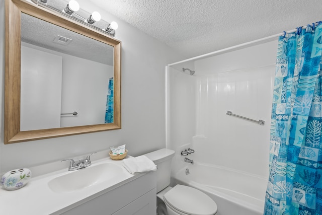 full bathroom featuring shower / bath combo with shower curtain, toilet, vanity, and a textured ceiling