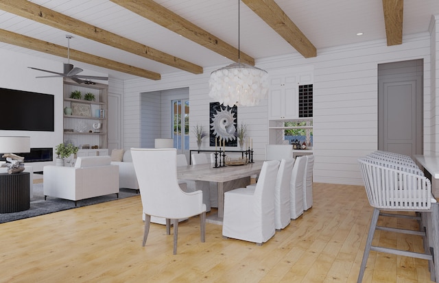 dining area with ceiling fan with notable chandelier, wood walls, light hardwood / wood-style flooring, and beamed ceiling