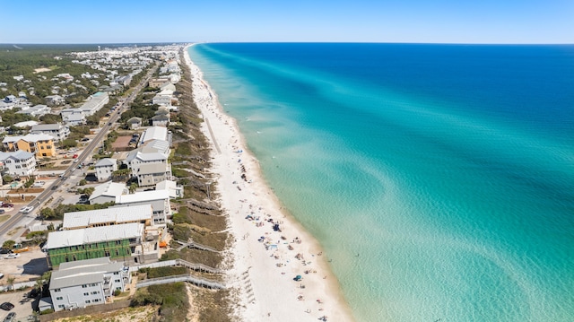 drone / aerial view with a water view and a beach view