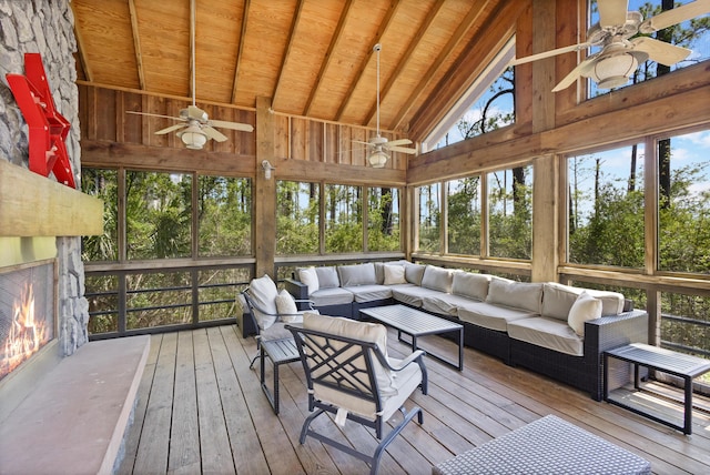 sunroom featuring lofted ceiling, wood ceiling, and ceiling fan