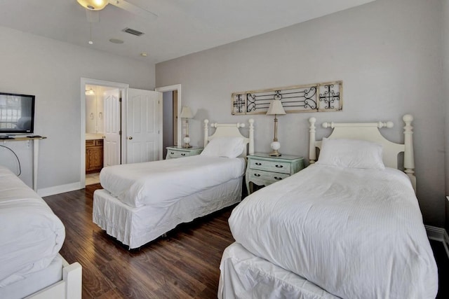 bedroom with dark wood-type flooring, ceiling fan, and ensuite bathroom