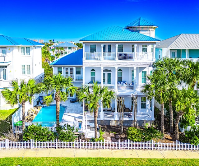 exterior space featuring a fenced in pool and a balcony