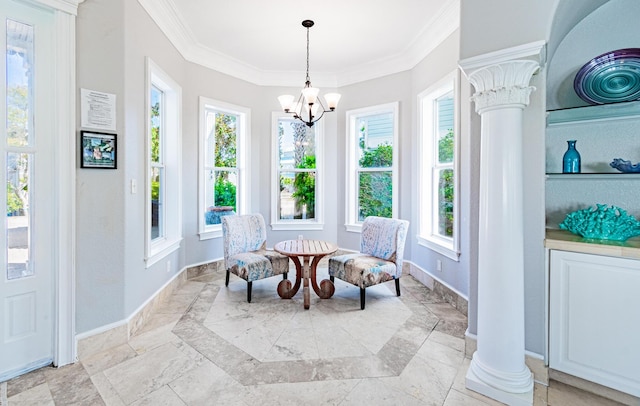 interior space with an inviting chandelier, ornamental molding, and decorative columns