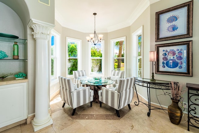 dining area with a notable chandelier, ornamental molding, and ornate columns