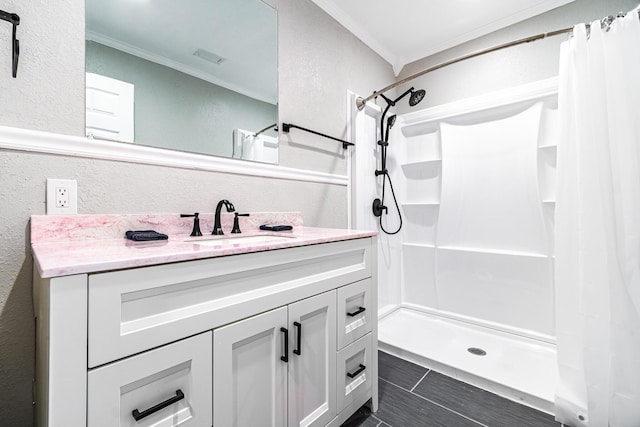 bathroom featuring vanity, ornamental molding, and curtained shower