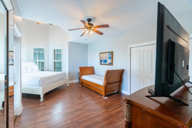 bedroom featuring ceiling fan, a closet, dark hardwood / wood-style floors, and vaulted ceiling